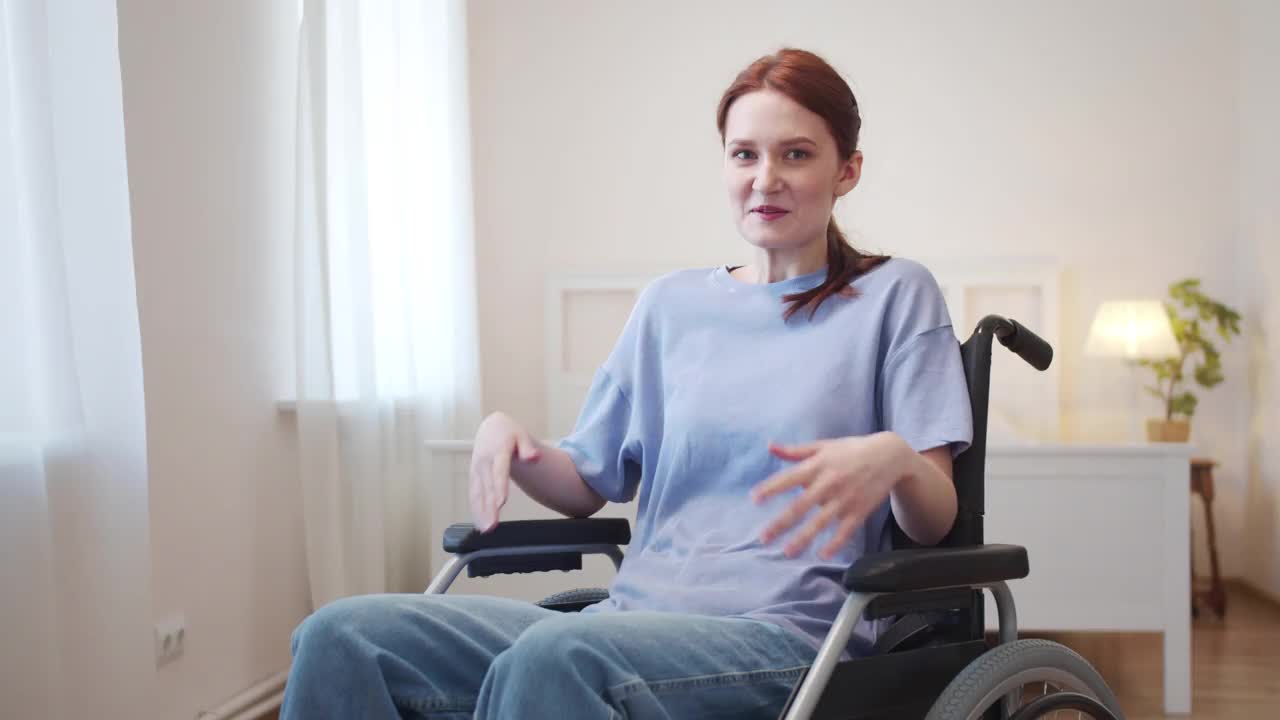 一个年轻的女人坐在轮椅上对着镜头说话视频素材