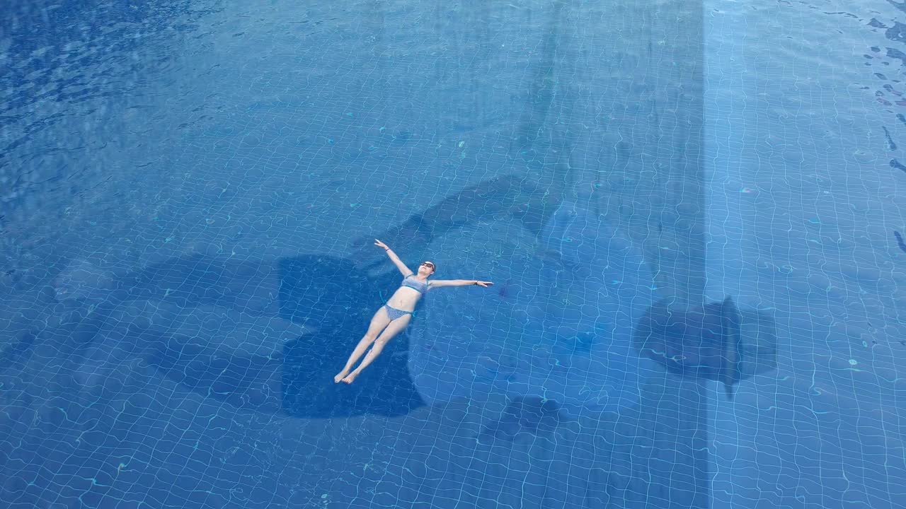 鸟瞰图苗条的女人漂浮。视频下载