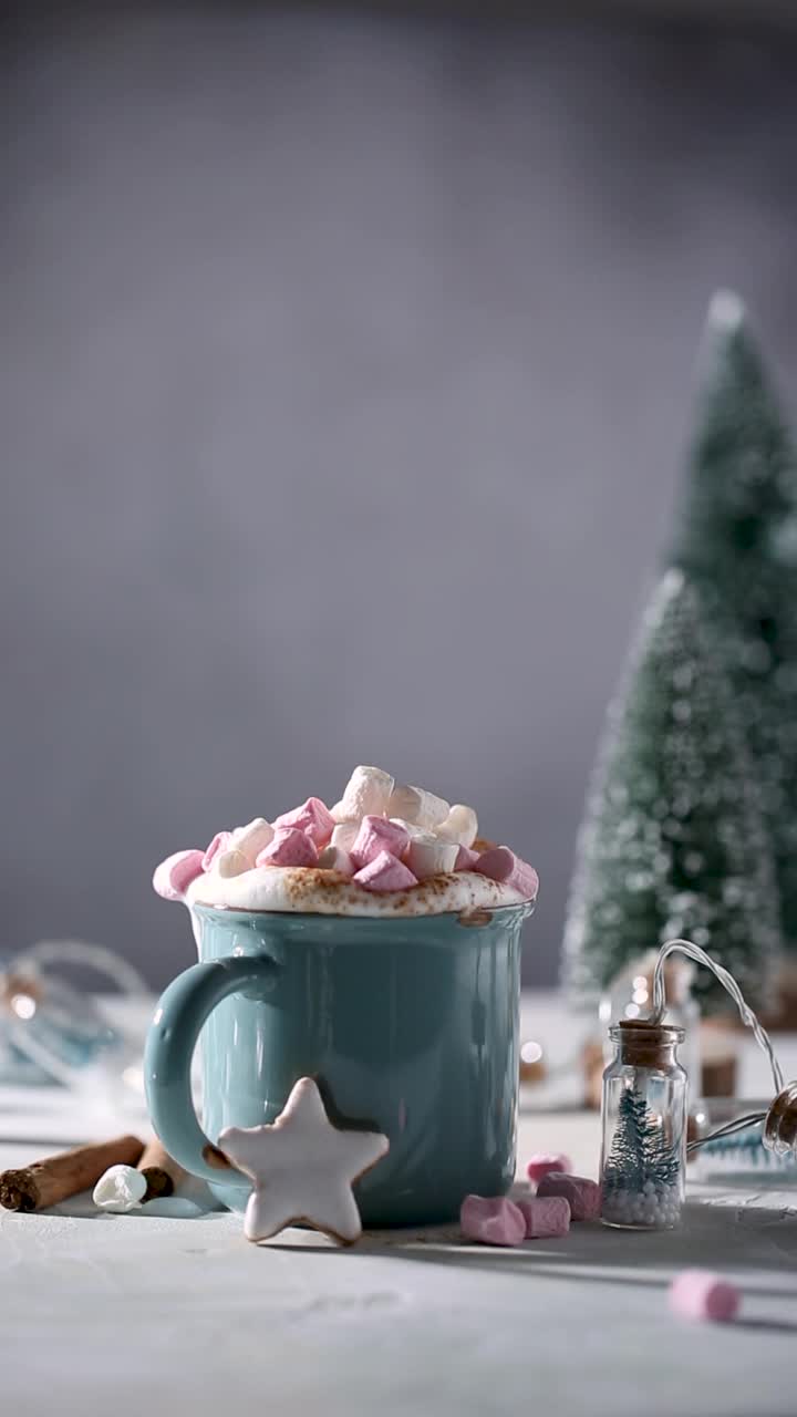 圣诞节喝。用丁烷厨房手电筒烤棉花糖，热巧克力装在蓝色杯子和装饰。全高清25 fps垂直视频素材视频素材