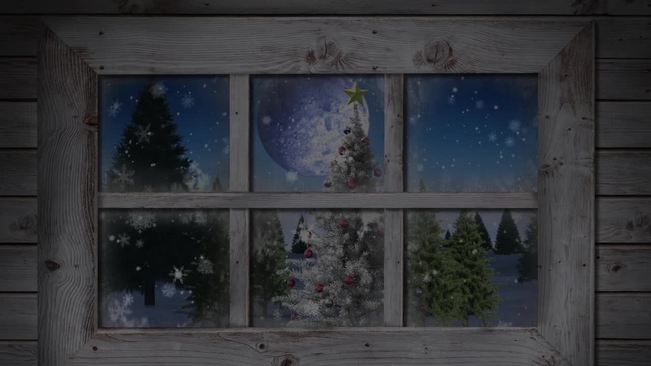 木窗框映衬着雪花飘落在圣诞树上的冬日风景视频素材