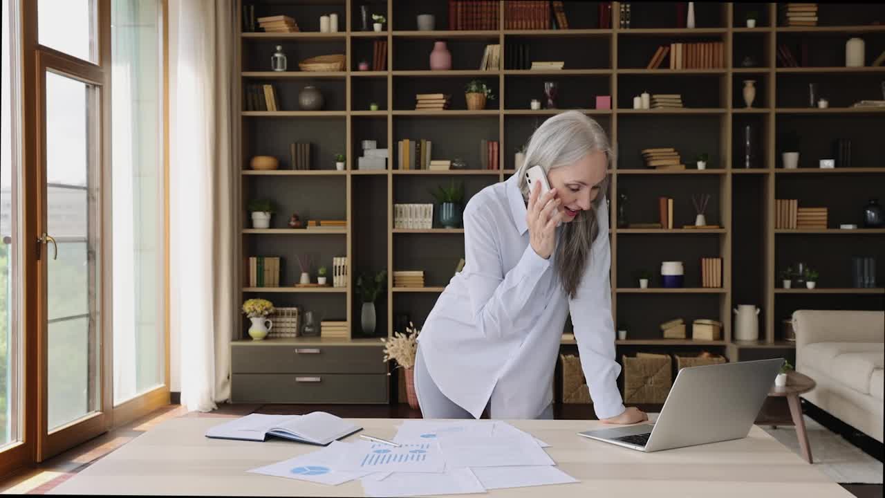 年长的成功女商人微笑着用手机打工作电话视频素材