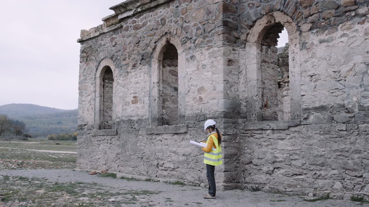 旧教堂的翻新。女工程师在现场采取措施。视频下载