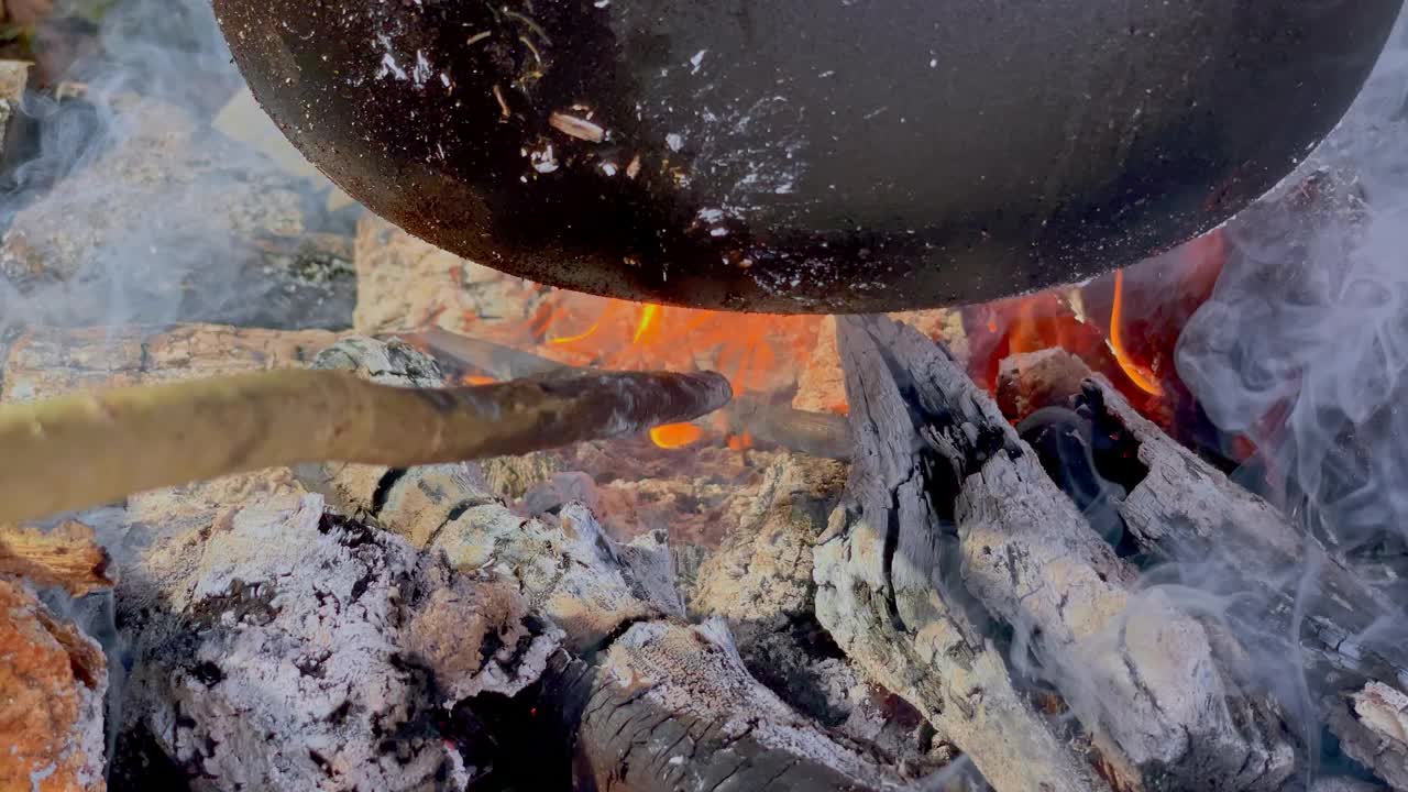 POV和朋友们围坐在篝火旁，用铁锅炖菜视频下载