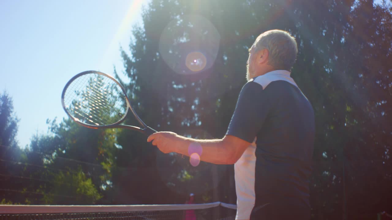 在一个阳光明媚的日子里，老男女打完网球后互相拥抱，谈笑风生视频素材