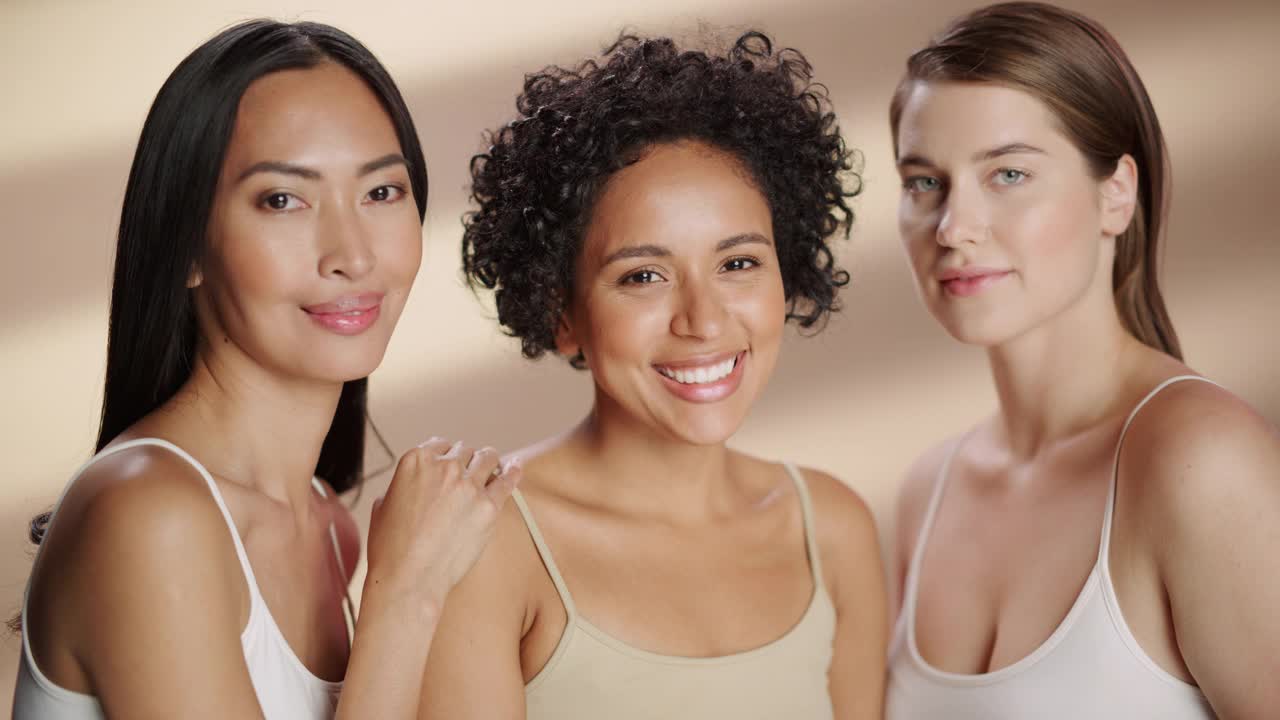 孤立背景下的三个多元民族模特的美丽肖像。肉欲快乐的亚洲，黑人和高加索妇女与自然，健康的皮肤。健康，水疗，美容，护肤概念。视频下载