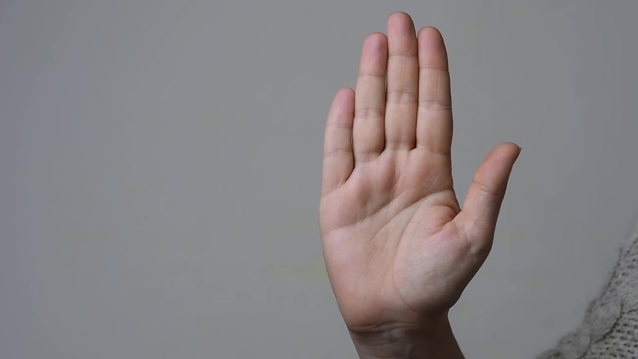 求助手势:一个女人的慢动作，展示了如何无声地做出请求帮助的手势视频下载