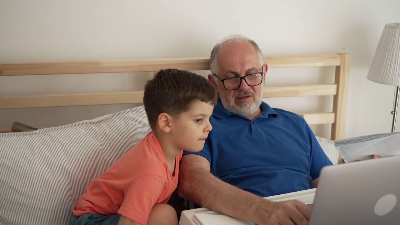 爷爷和孙子一起使用笔记本电脑视频素材