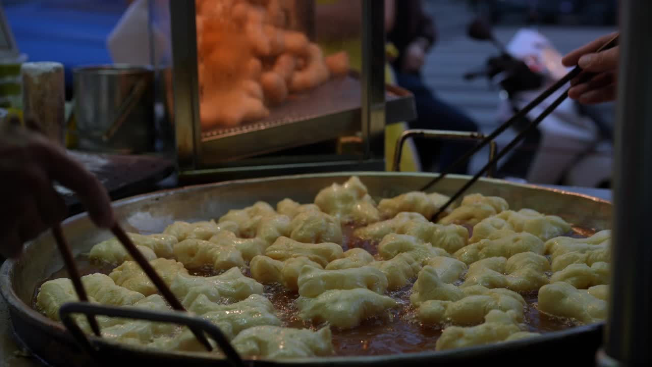 在沸油中油炸的面条。泰国甜甜圈- Patong Ko。油条是泰国人和亚洲人在街头小吃中的早餐。有选择性的重点视频下载