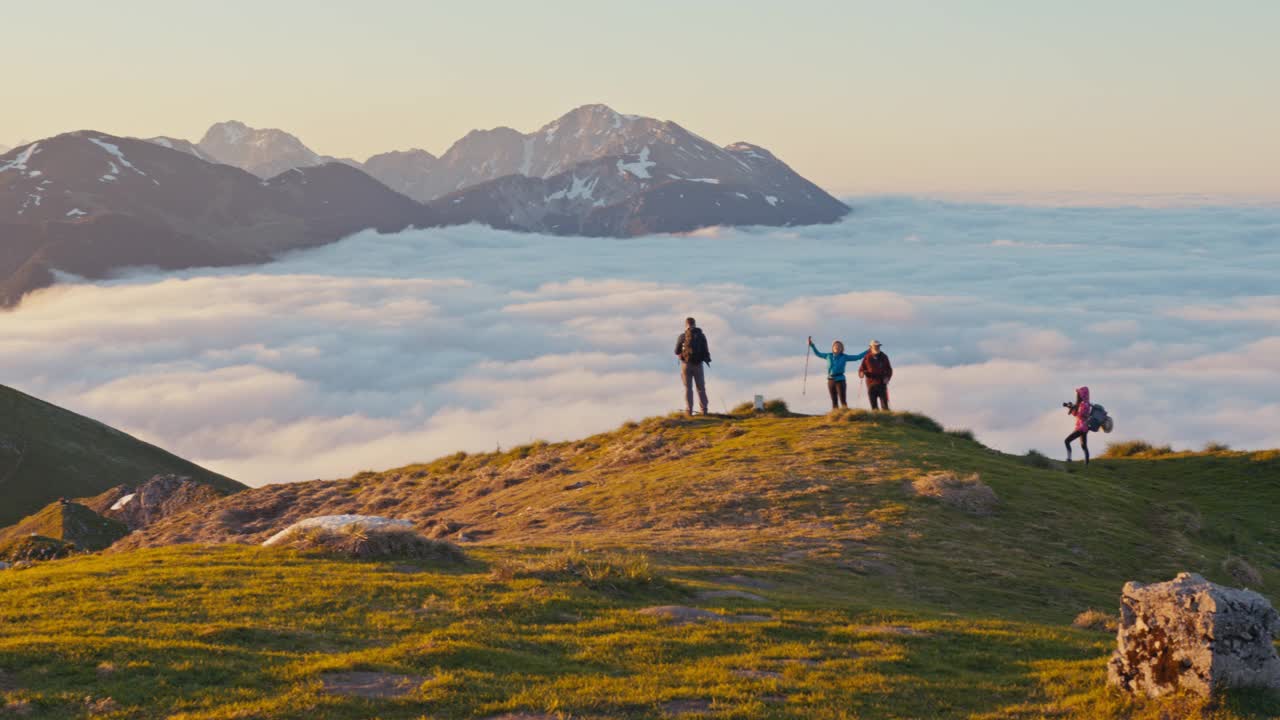 一群徒步旅行者在山顶欣赏风景视频下载