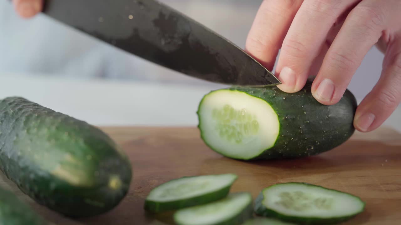 在厨房菜板上切黄瓜的人视频下载