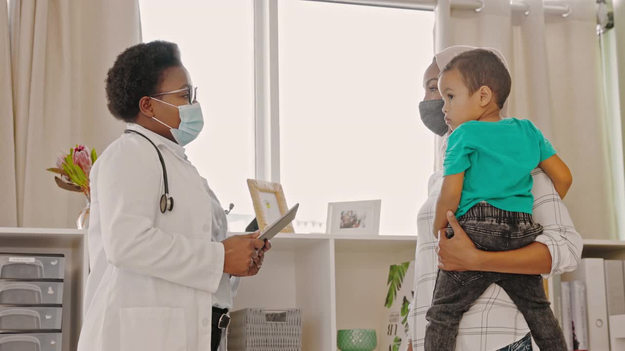 一名蒙面医生在给一个小男孩和他的母亲看病时碰了碰手肘的4k视频视频下载