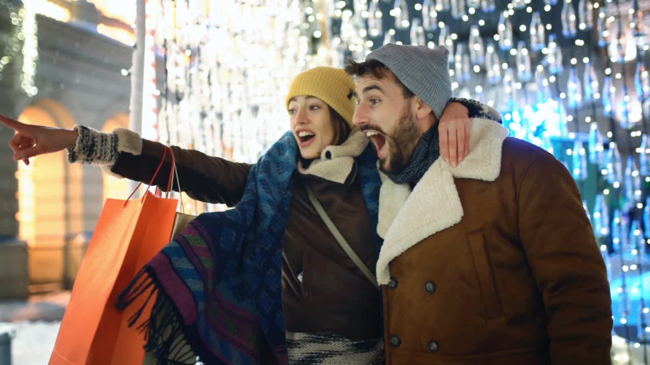下雪的夜晚，一对夫妇在圣诞市场慢动作。视频素材