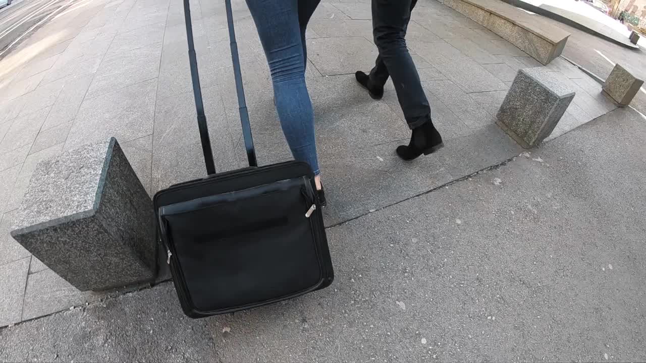 商务同事，穿着外套的夫妇，西装革履的拖着行李箱去机场出差，慢动作视频素材