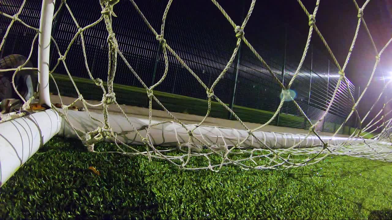 目标!足球(足球)击中球门后面，反弹并击中摄像机。视频素材