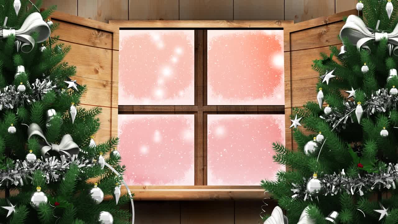 两棵圣诞树和木制窗框上的雪花飘落在粉红色的背景视频素材