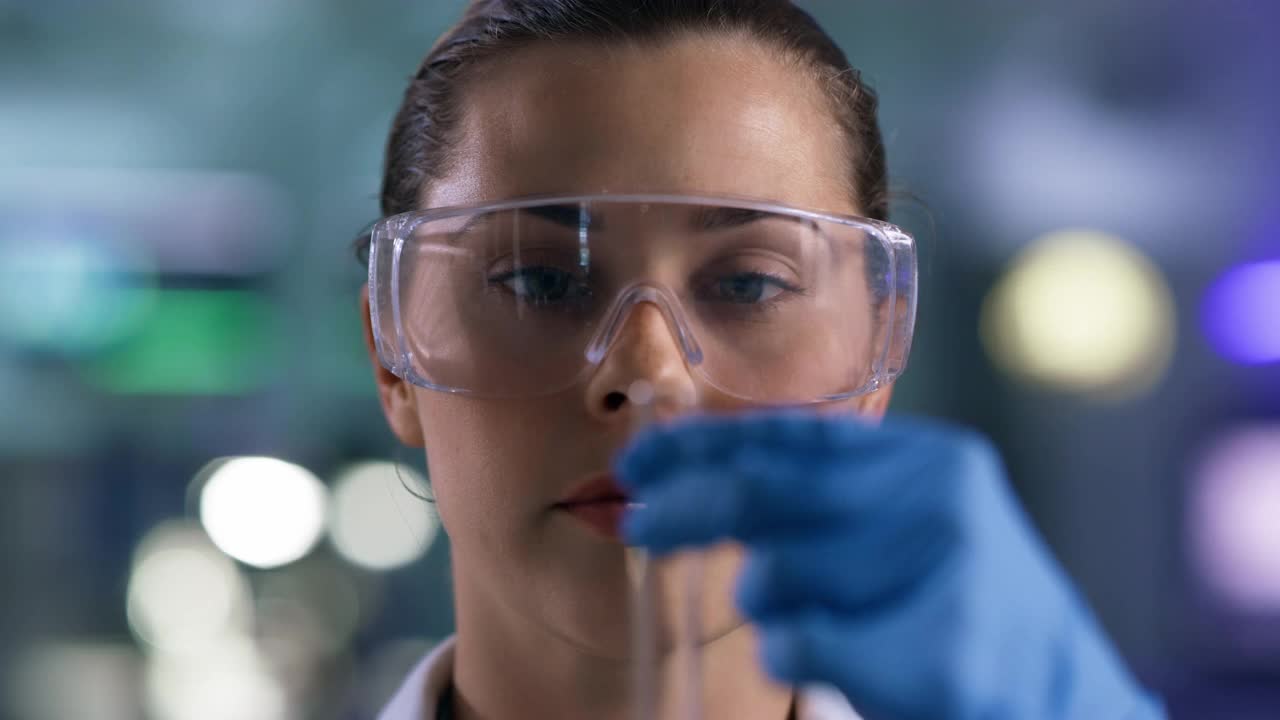 一个年轻女子在实验室里使用滴管和试管的4k视频片段视频素材