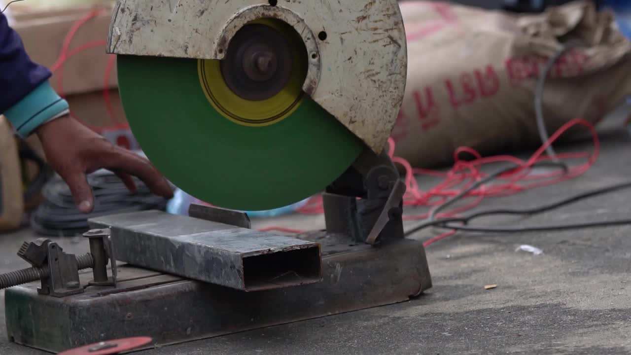 工人切割金属。正在用锋利的圆形刀片切割金属和钢的人视频素材