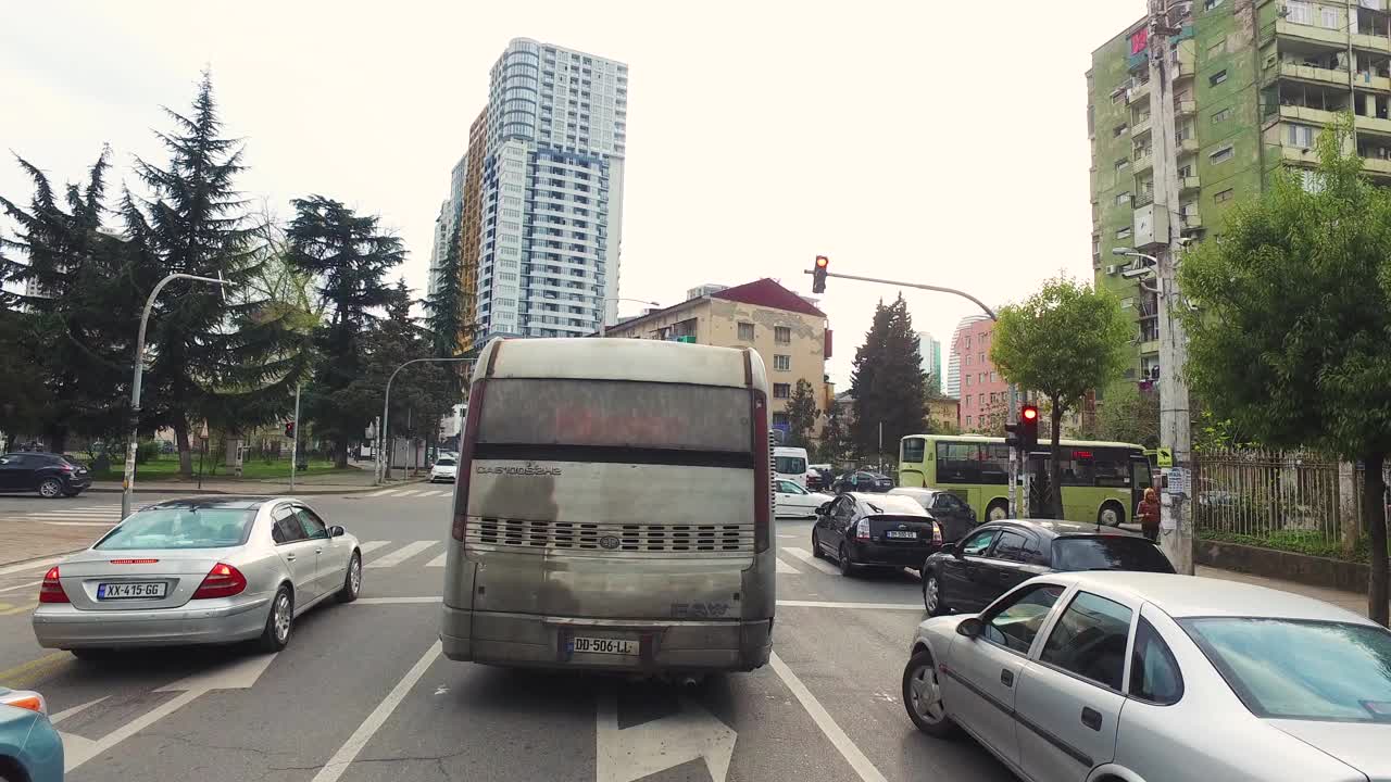 在城市中行驶的老旧的冒烟的公共汽车。视频下载