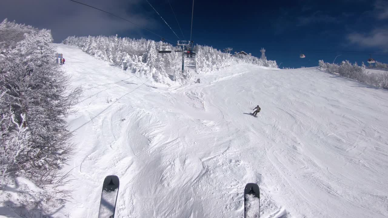 冬季滑雪度假。在滑雪缆车和缆车中用滑雪板进行POV。在雪坡上滑雪，人们在雪天玩耍——冬季运动和户外活动。视频下载