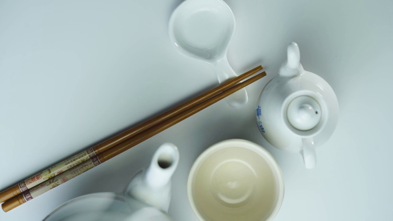 高角度的茶壶与茶杯和筷子视频下载