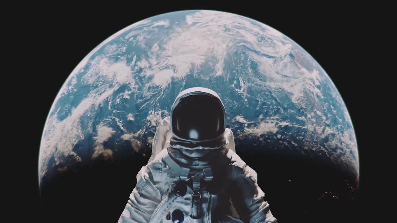 一名宇航员以地球为背景的放大镜头。视频下载