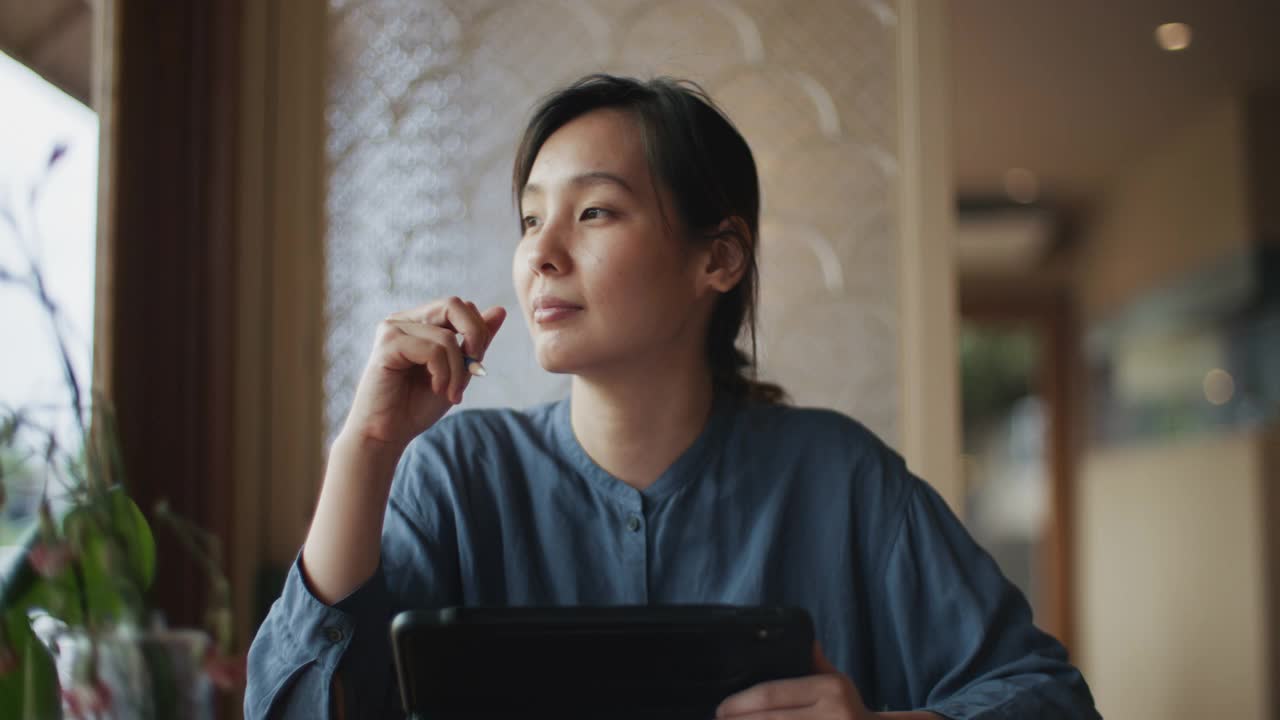 亚洲女性在咖啡馆使用笔记本电脑视频素材