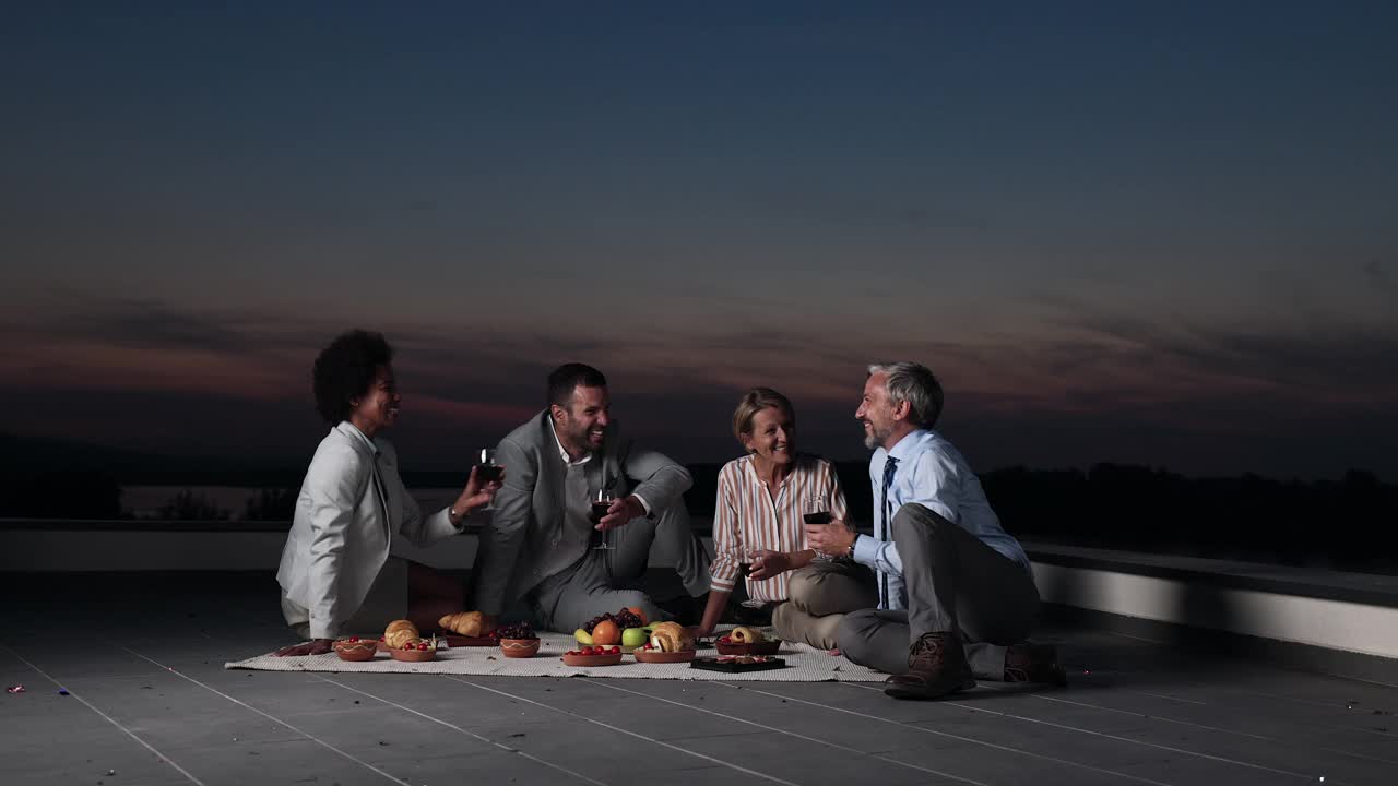 愉快的商务同事在屋顶野餐。视频下载