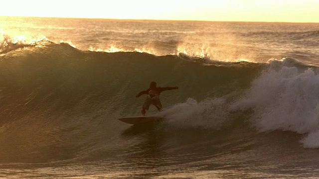 日落时，冲浪者乘风而上，慢镜头视频素材
