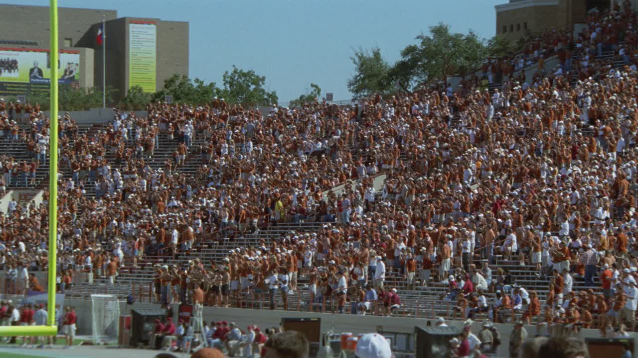 广角观众或球迷在体育场欢呼德州大学的橄榄球比赛。达雷尔k.皇家纪念体育场。人群的欢呼声。投篮得分门柱。视频素材