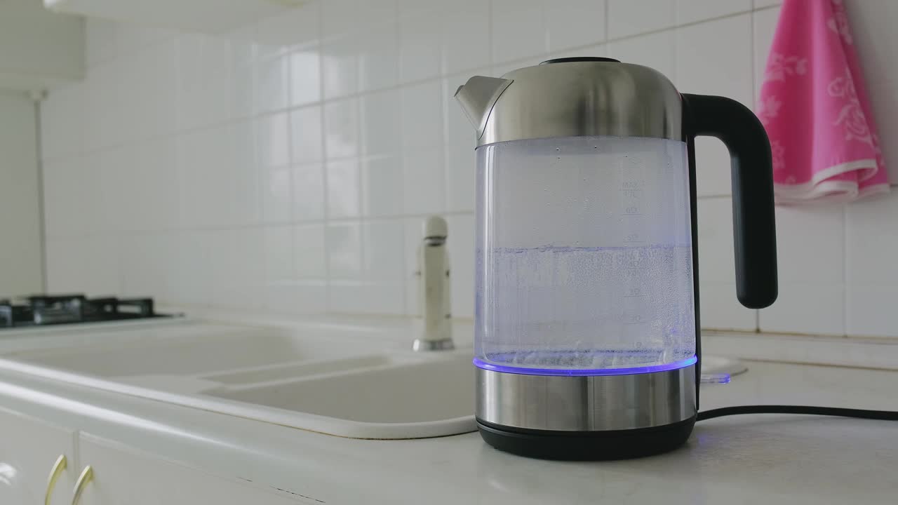 透明水壶的水在厨房沸腾。沸水的过程视频素材