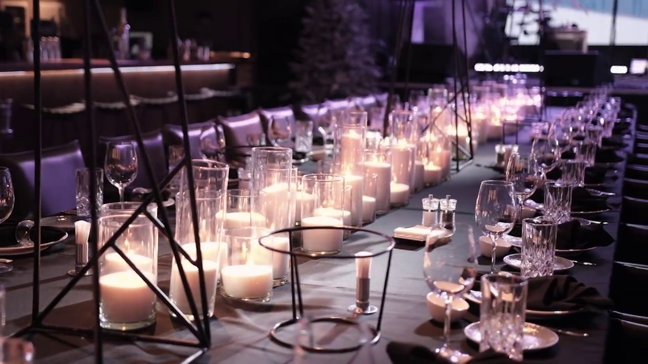 优雅的餐桌上有眼镜，点燃的蜡烛视频素材