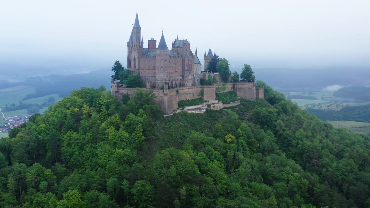 空中拍摄的青山上的古堡风景，无人机在绿色植物上飞行-比辛根，德国视频下载