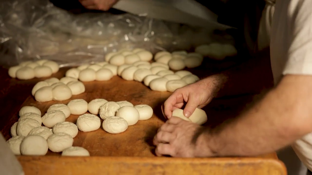 熟练的面点师在面包房厨房里制作小圆面包视频素材