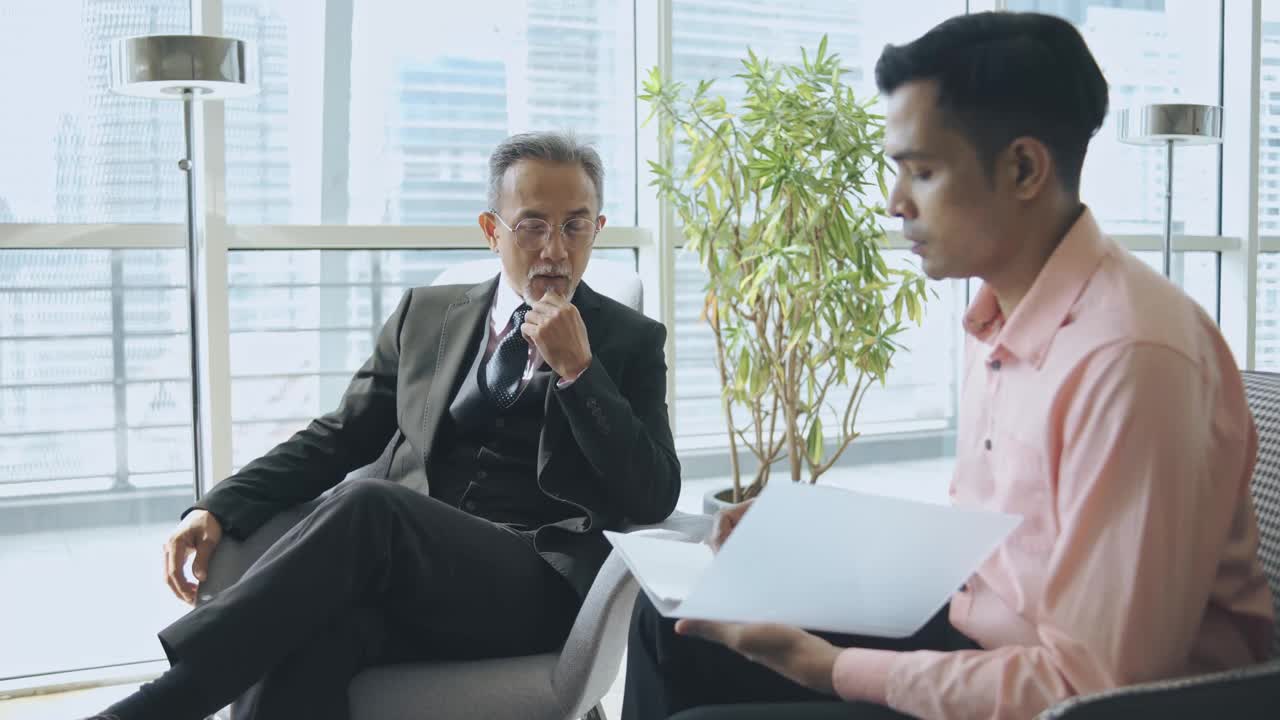 成功的亚洲华人CEO在办公室与他的秘书和私人助理谈话视频下载