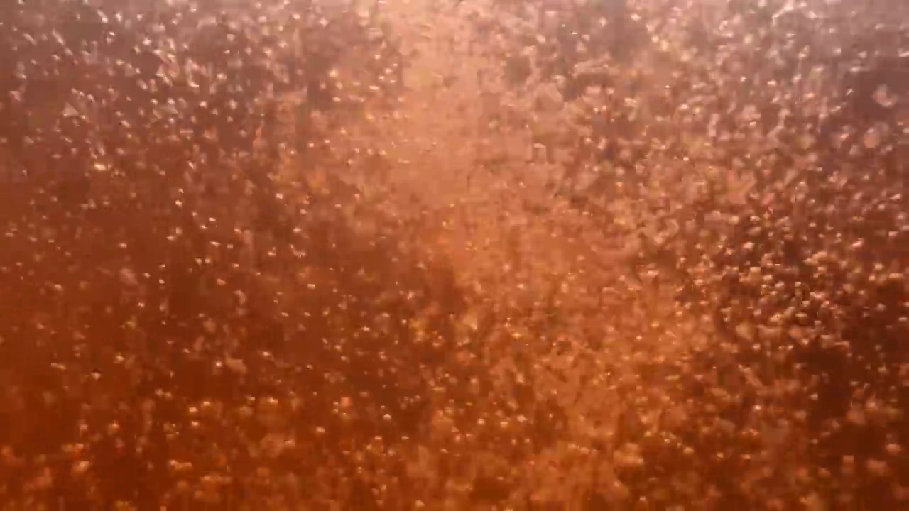 一杯橙水里的水冒着气泡视频素材
