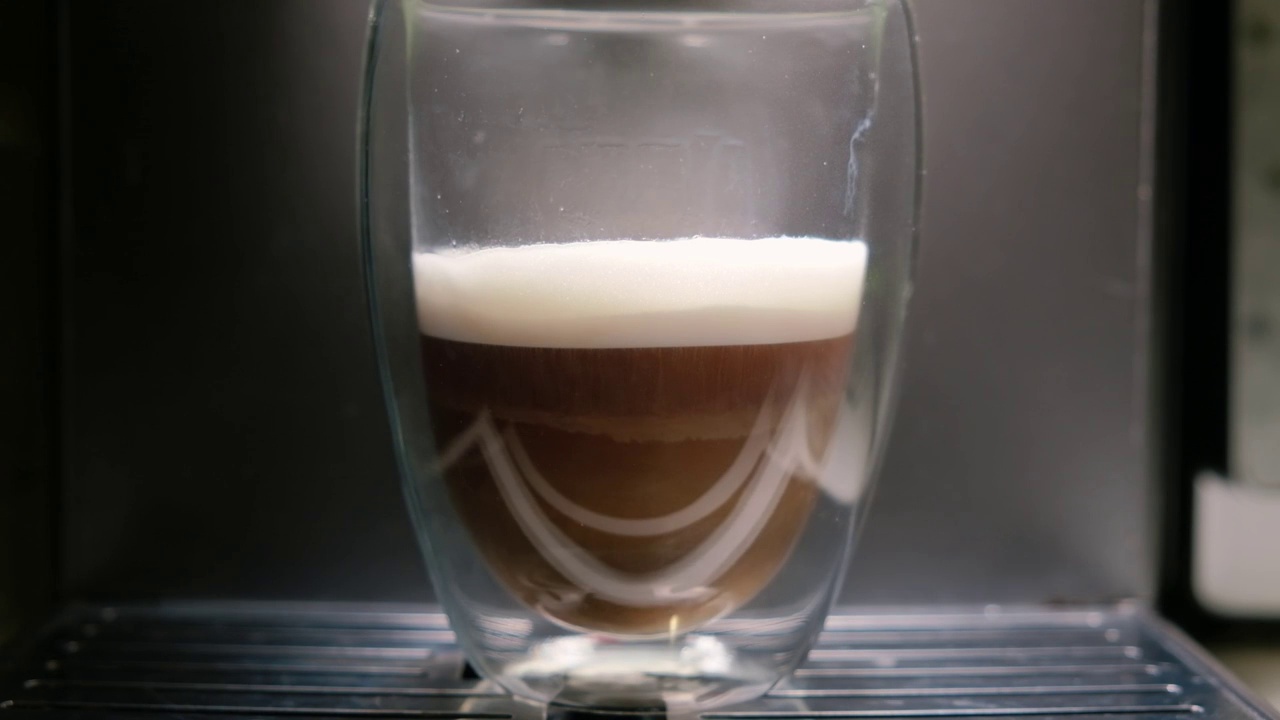 咖啡机旁边的杯子里的特写卡布奇诺视频素材