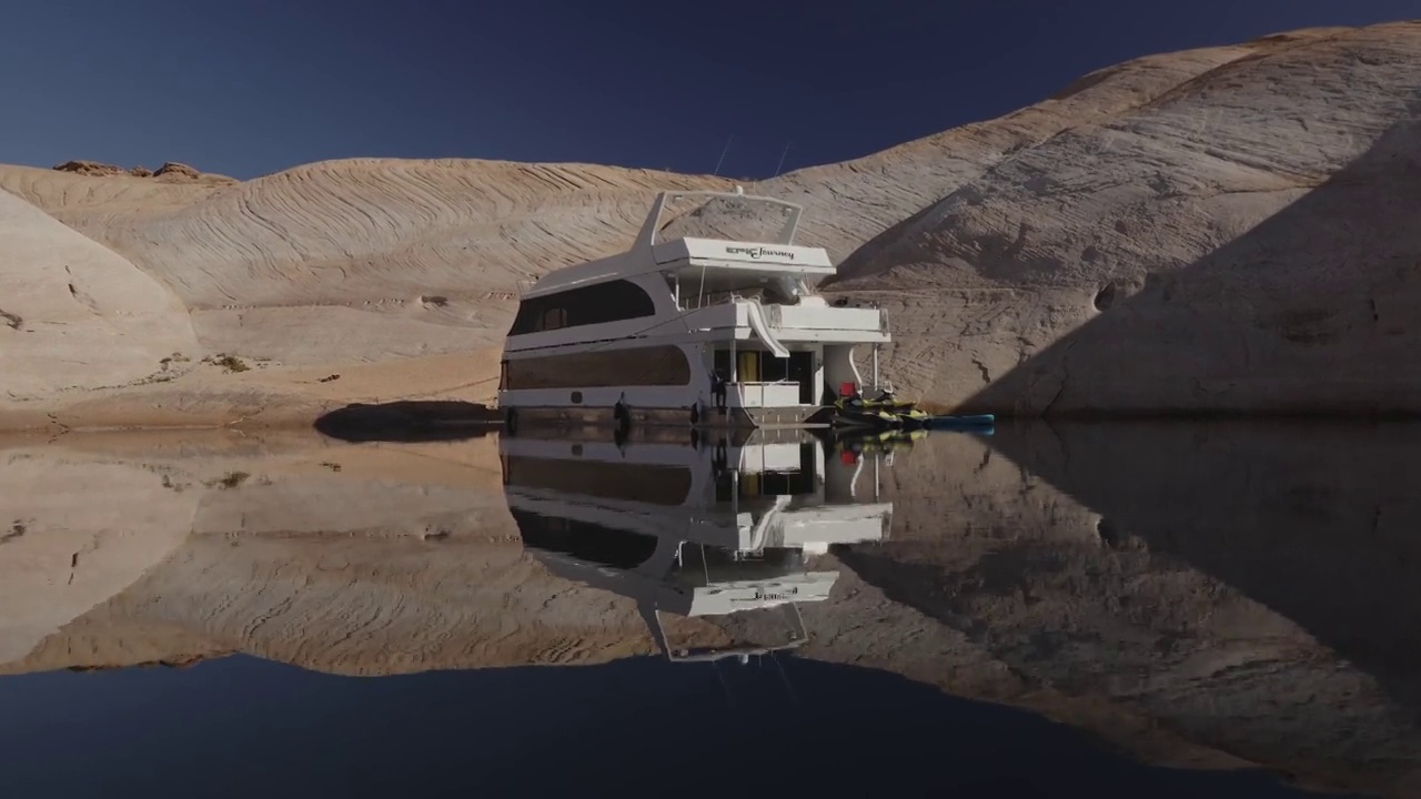 飞越峡谷湖的游艇和岩石的反射/格伦峡谷，犹他州，美国视频下载