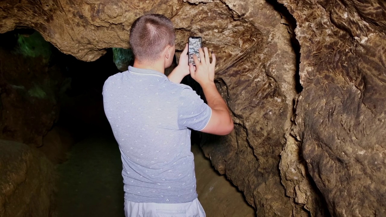 一个游客在地下城的洞穴里拍照。视频素材