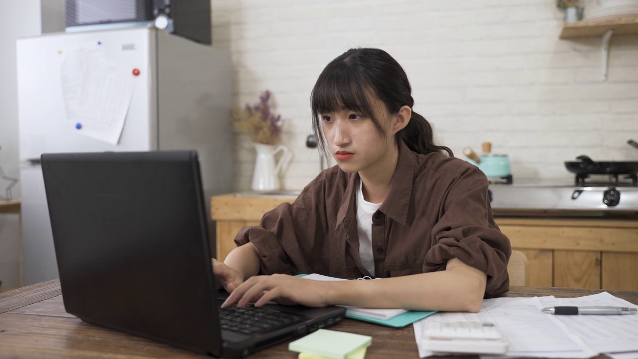 图为，白天在餐厅用电脑工作的亚裔女职员的肖像。视频素材
