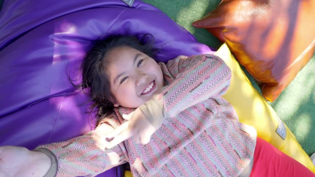 快乐的女孩躺在垫子上和有趣的跳舞视频下载
