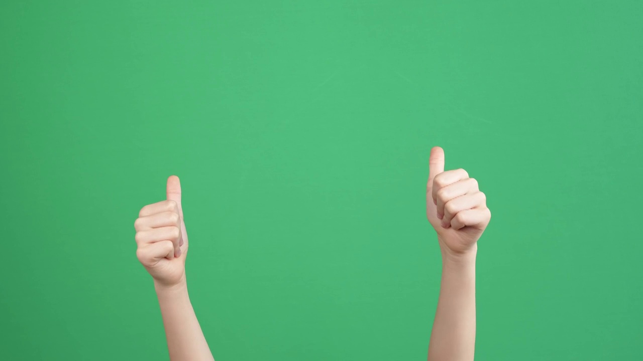 小孩用手指着某人或某物，数数，并在绿色屏幕的色度键背景上伸出两只大拇指。4 k的视频视频素材