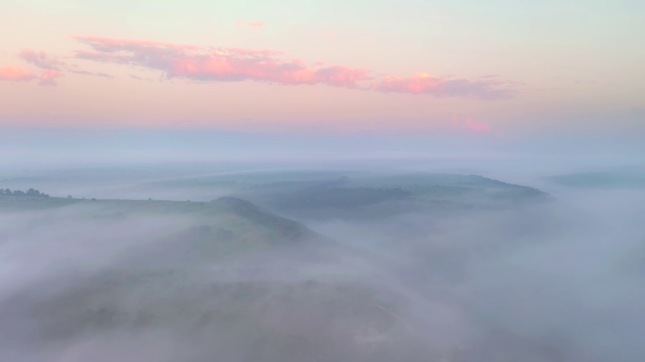 无人机在清晨浓雾笼罩的农田上空飞行。视频素材