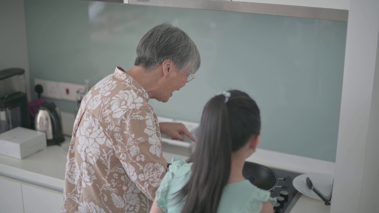 亚裔华人奶奶在周末的闲暇时间教她的奶奶在厨房做饭视频下载
