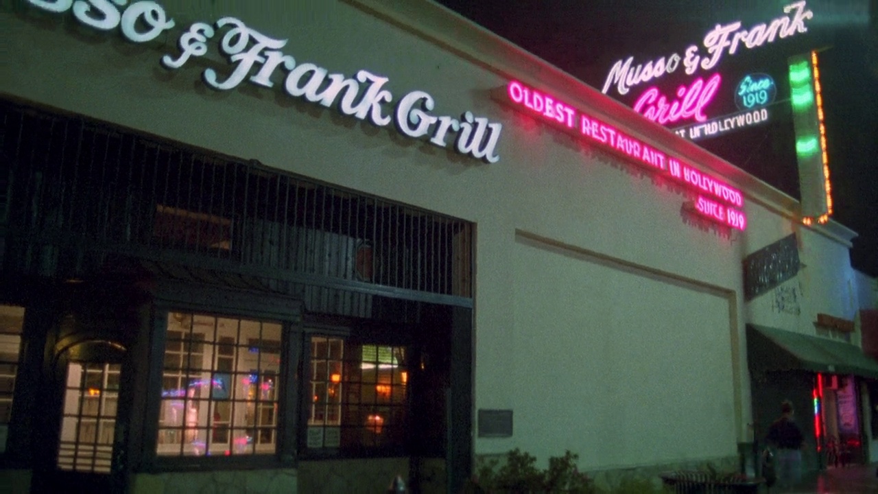 将餐厅入口的“musso & frank grill”招牌从右向左移至餐厅“musso & frank grill”上方的霓虹灯招牌。室内餐厅通过玻璃窗户和门。好莱坞的大街。视频下载