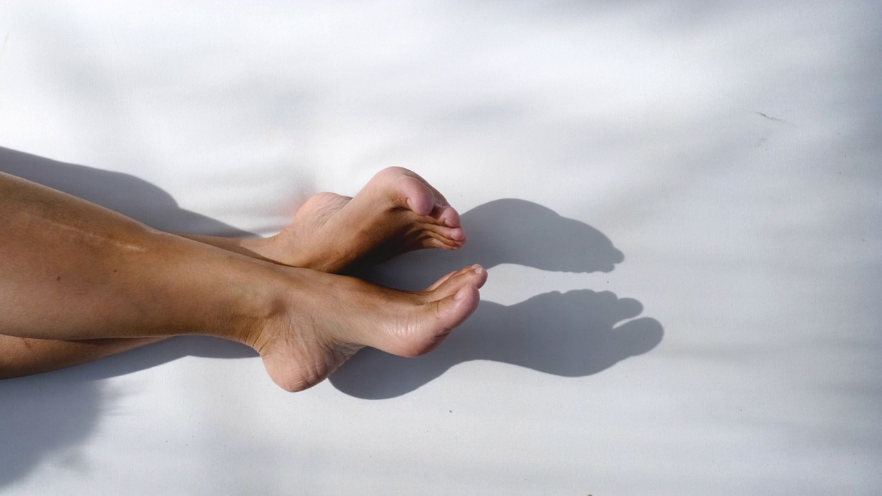 近光脚交叉腿躺在海滩床椅子在海上视频下载