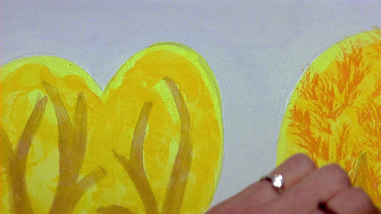 女人与钻石戒指在她的手与水彩画，添加简单的橙色叶子圆黄色的树的近角度。视频下载