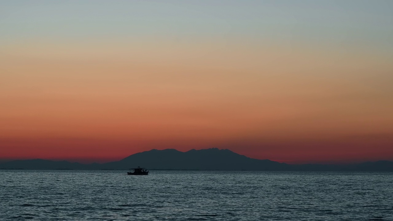 爱琴海上的夕阳，移动的船，远处的陆地，水，希腊视频素材