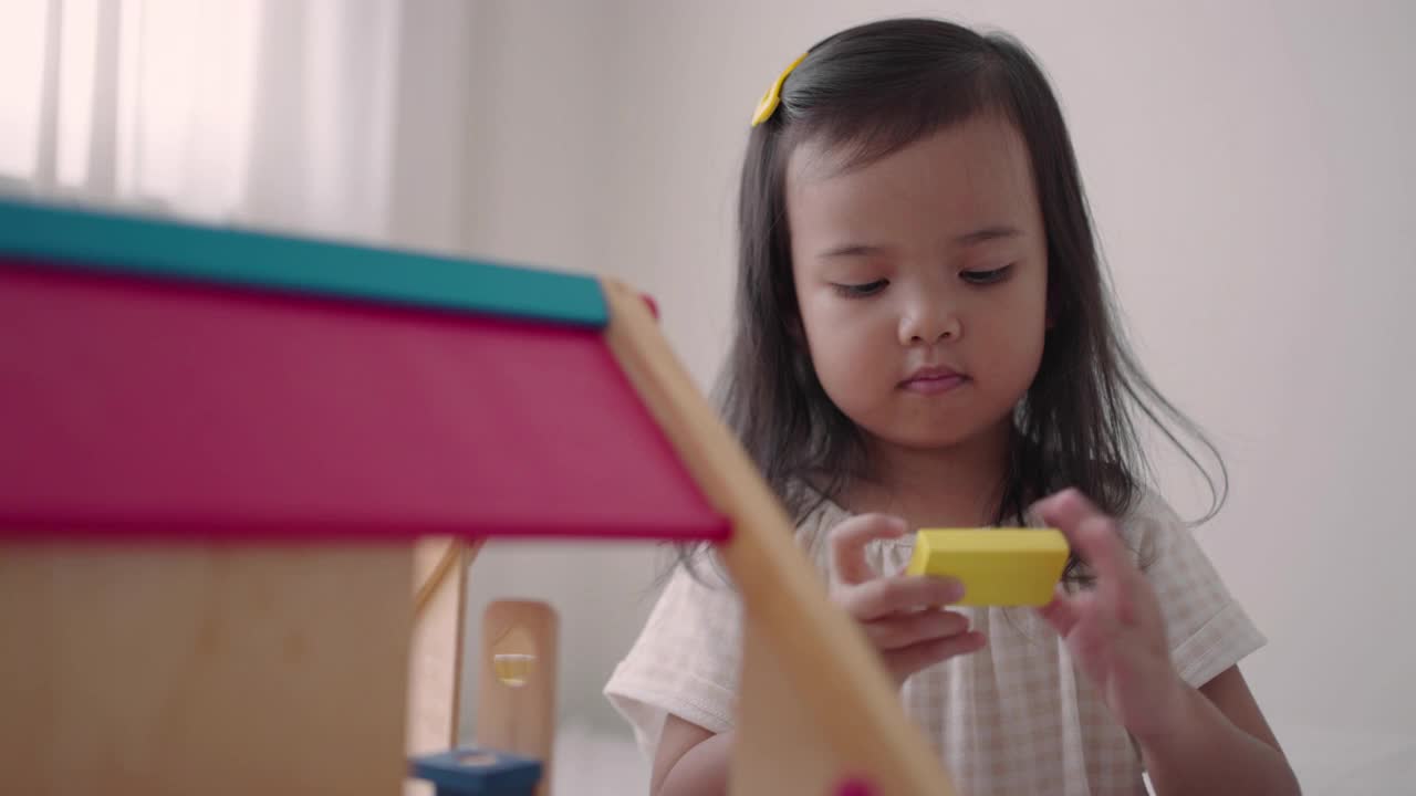 亚洲小女孩在家里玩木房子玩具视频下载