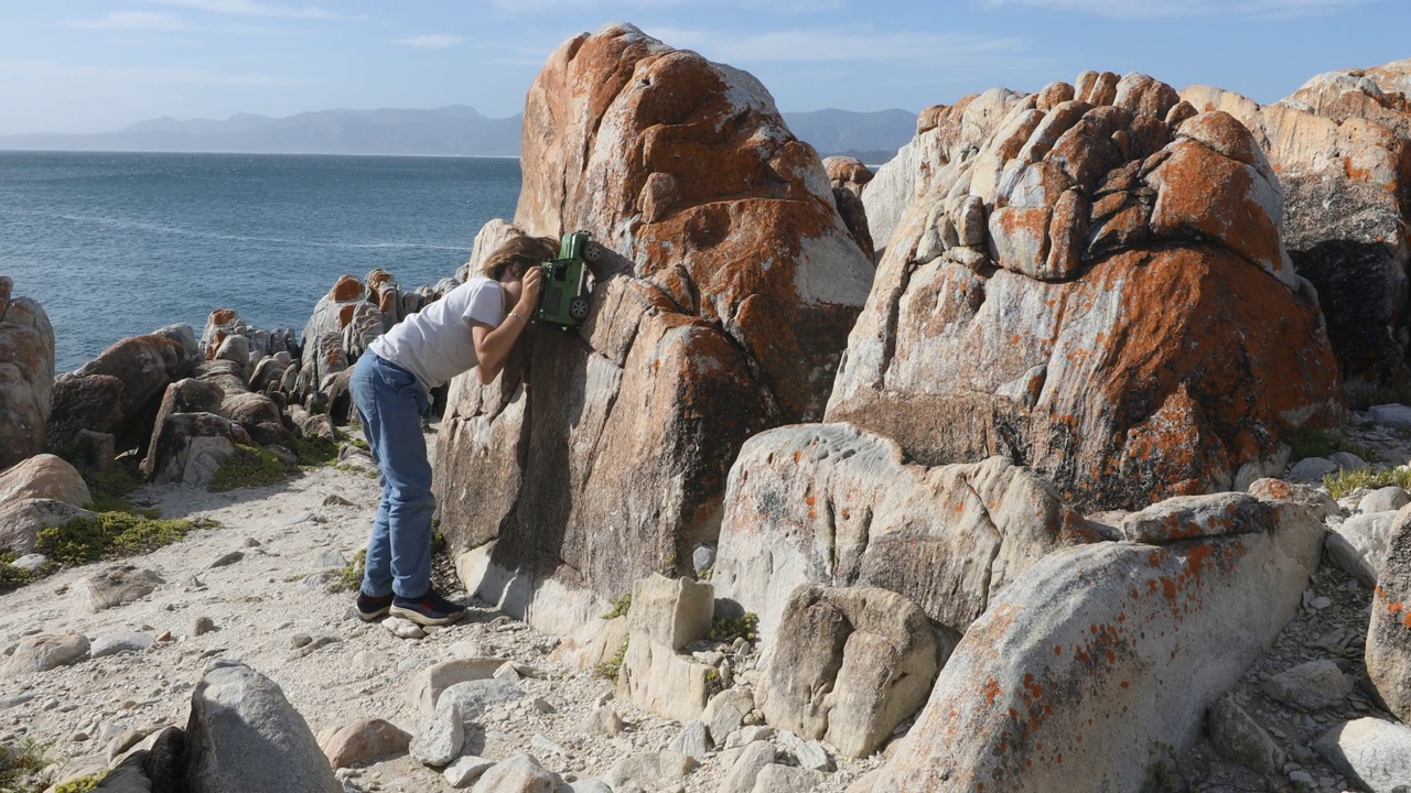 小男孩探索岩石海岸，岩石，德科德斯，南非视频素材