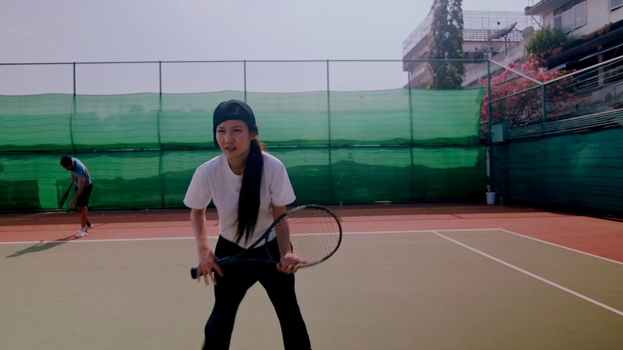 业余网球双打即将发球的慢动作动态镜头。放大。视频下载
